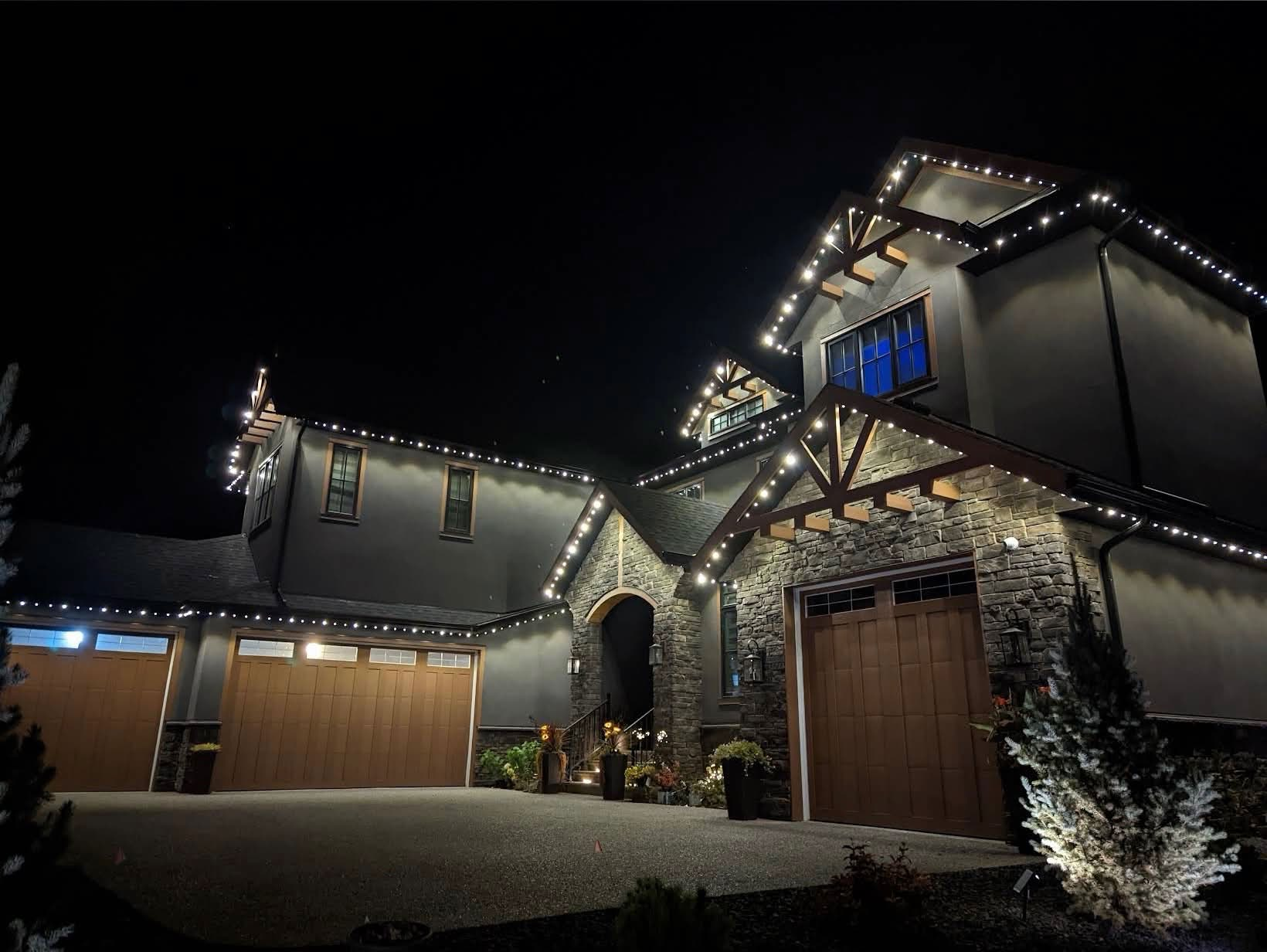 White permanent lights following the peaks of a multi-level home